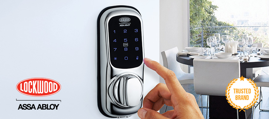 Hand touching Lockwood Digital Lock in house